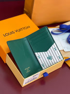 Louis Vuitton teal-green leather card holder open view with patterned insert