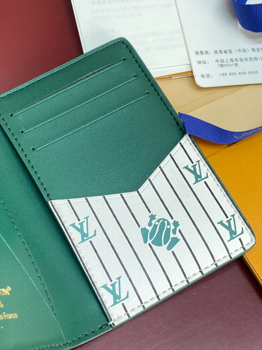 Louis Vuitton teal-green leather card holder with multiple card slots