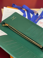 Teal small wallet with gold zipper and embossed card slot rows