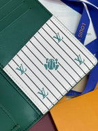 Teal small wallet interior showing striped panel with LV logos and stitching