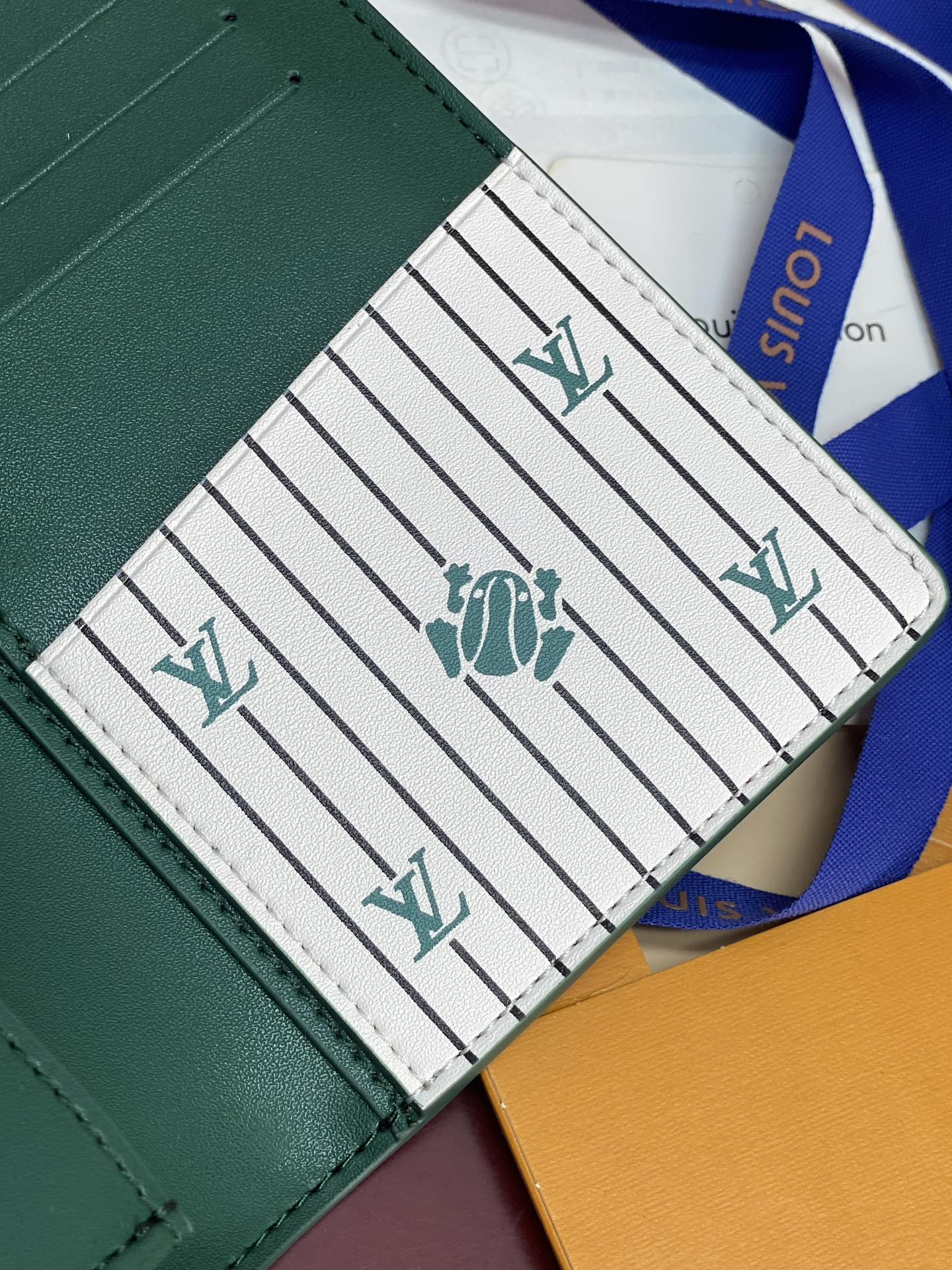 Louis Vuitton green wallet interior with logo on striped pocket