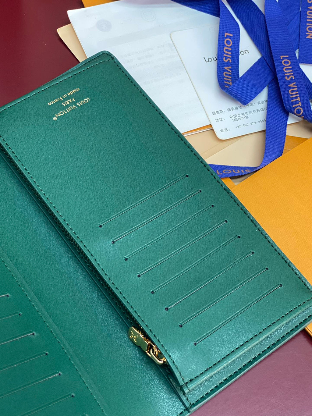 Teal small wallet with card slots and gold-tone zipper hardware on the front