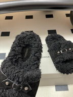 Black Balenciaga fuzzy sandals with ankle-style strap and metal buckle