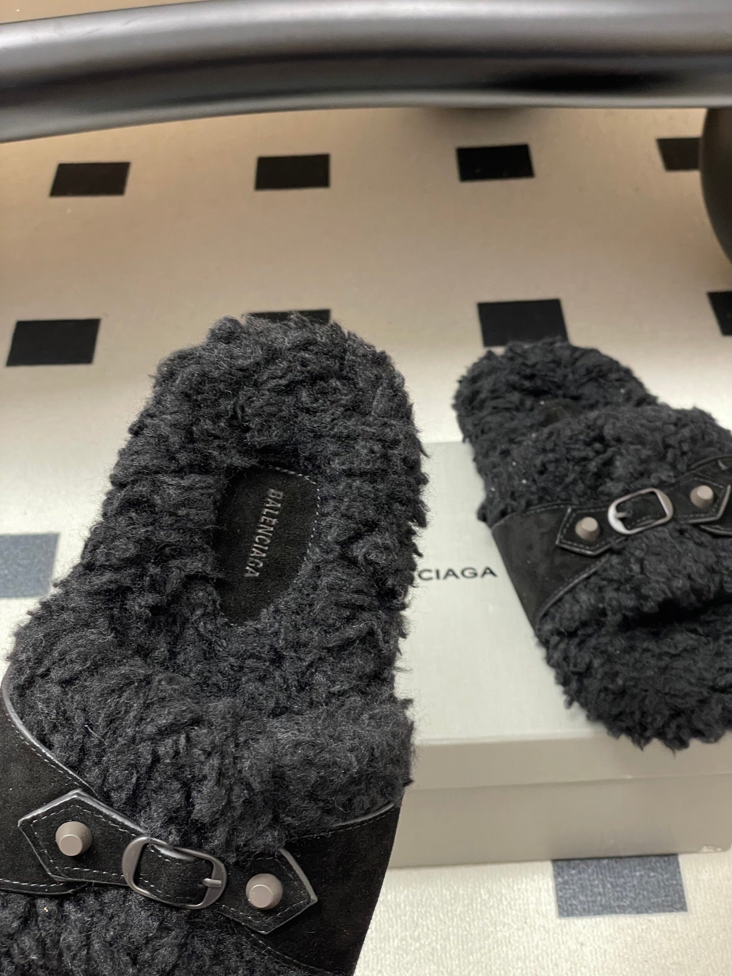Black Balenciaga fuzzy sandals with ankle-style strap and metal buckle