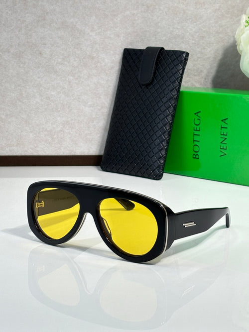 Bottega Veneta black sunglasses with mirrored yellow lenses and side logo bar