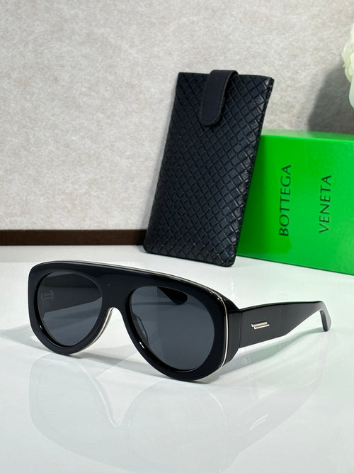 Bottega Veneta black sunglasses with dark lenses and gold-tone logo detail