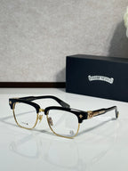 Chrome glasses, black with gold-tone accents, clear lenses