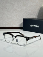 Chrome glasses, black frames with gold-tone detailing, clear lenses