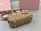 Taupe quilted leather mini bag with gold studs, removable strap, and front logo plaque