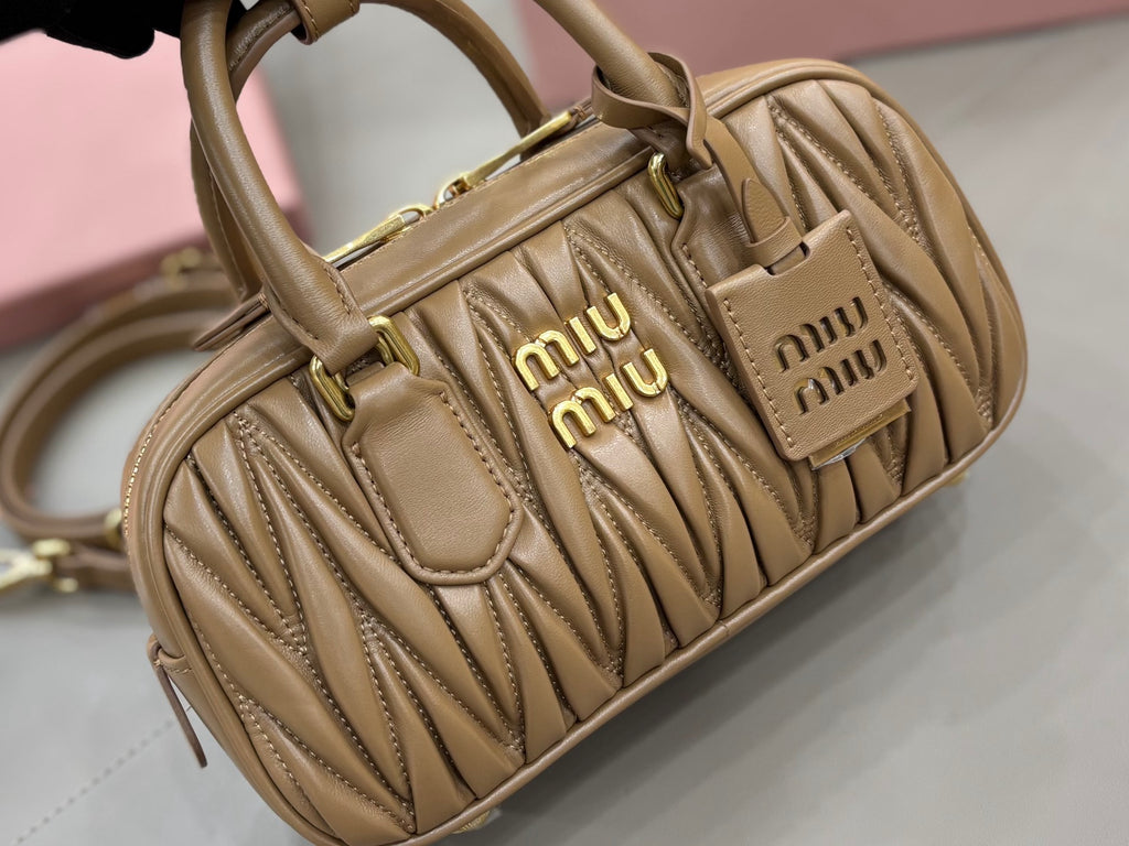 Taupe quilted leather mini bag with front Miu Miu logo plaques and top handles