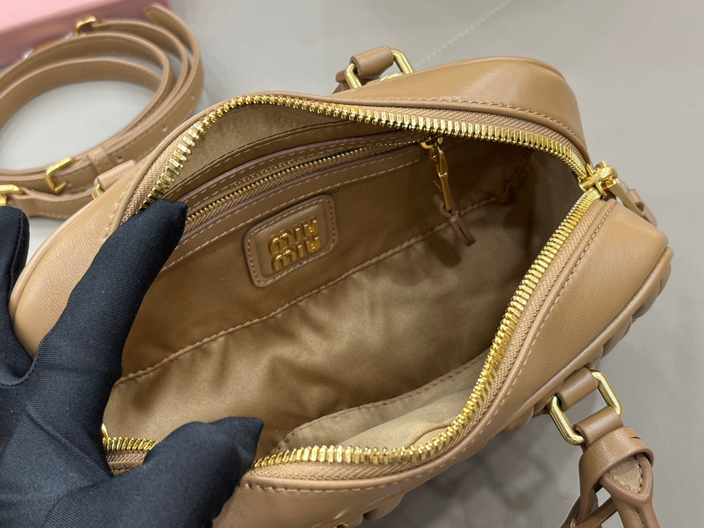 Taupe leather mini bag interior with zip pocket and beige lining