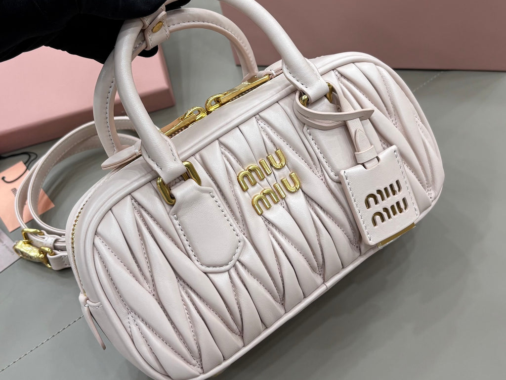MiuMiu light gray quilted mini bag with adjustable shoulder strap and logo details