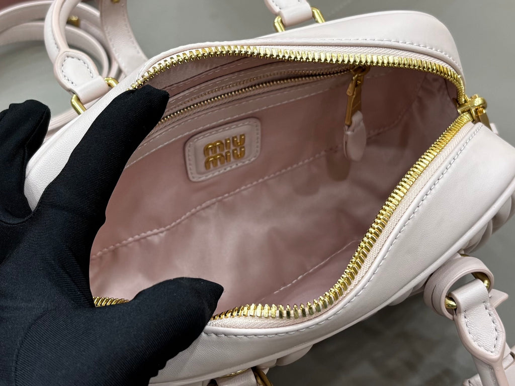 MiuMiu light gray mini bag interior view with zipped compartment and logo patch