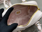 MiuMiu light gray mini bag interior view with zipped compartment and logo patch