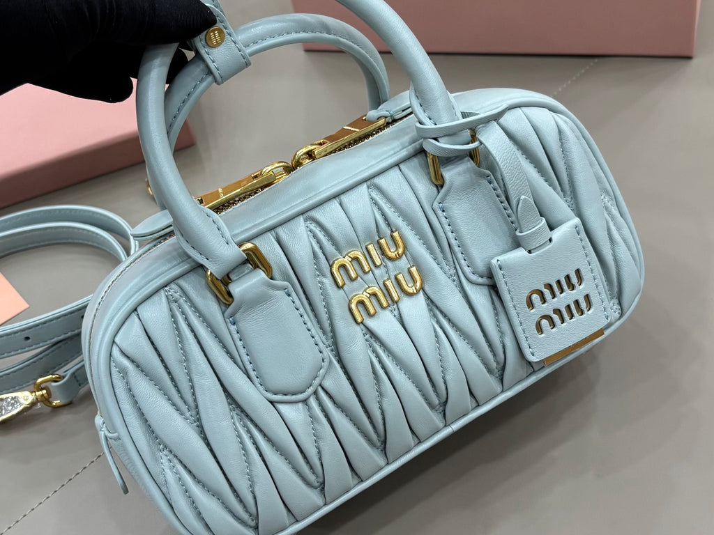 MiuMiu light blue quilted mini bag with top handles and MiuMiu logo front