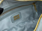 MiuMiu light blue mini bag close-up of interior logo patch and gold zipper