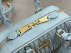 MiuMiu light blue mini bag close-up of top zipper bar and handle strap