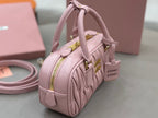 Miu Miu light pink mini top-handle bag with side view and crossbody strap