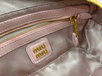 Miu Miu light pink inner pocket with logo patch and gold zipper close-up
