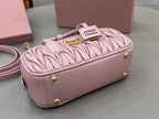 Miu Miu light pink mini gathered bag with gold feet and logo tag