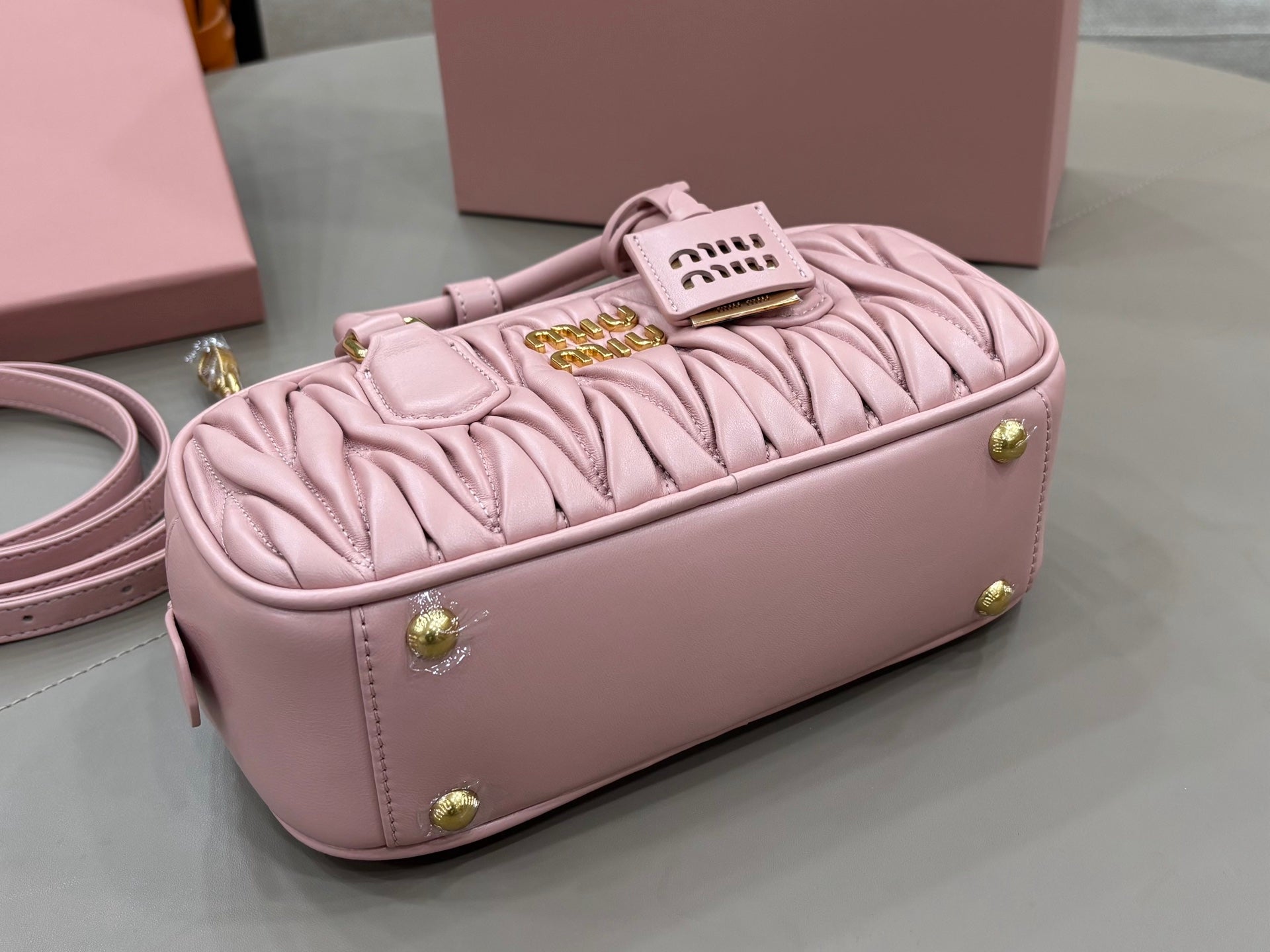 Miu Miu light pink mini gathered bag with gold feet and logo tag