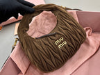 MiuMiu ruched hobo bag front close-up with miu miu logo, olive-brown fabric