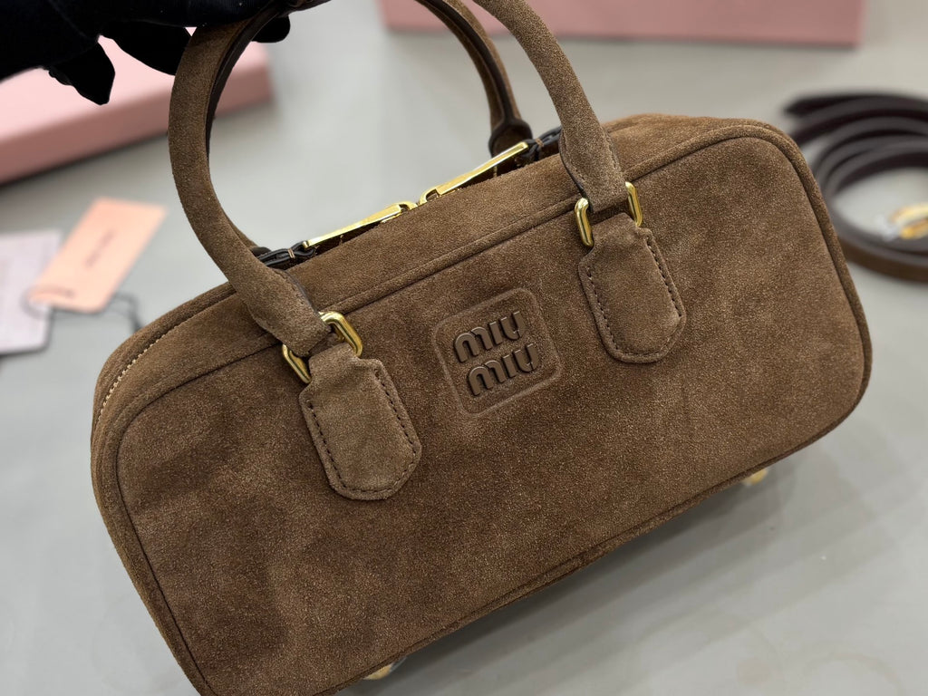 Suede mini top-handle bag with gold-tone buckle hardware and central Miu Miu logo