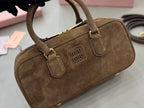 Suede mini top-handle bag with gold-tone buckle hardware and central Miu Miu logo