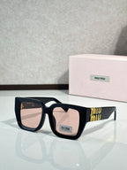 Square dark sunglasses with light-tinted lenses and gold “miu miu” logo on the temple