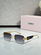 MiuMiu gold-tone sunglasses with dark gradient lenses and logo temple tips