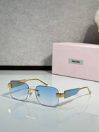 Gold-tone sunglasses with blue-tinted lenses and logo temple accents