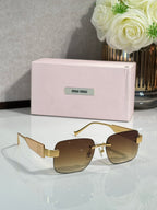Gold-tone sunglasses with amber lenses and logo on the temple arms