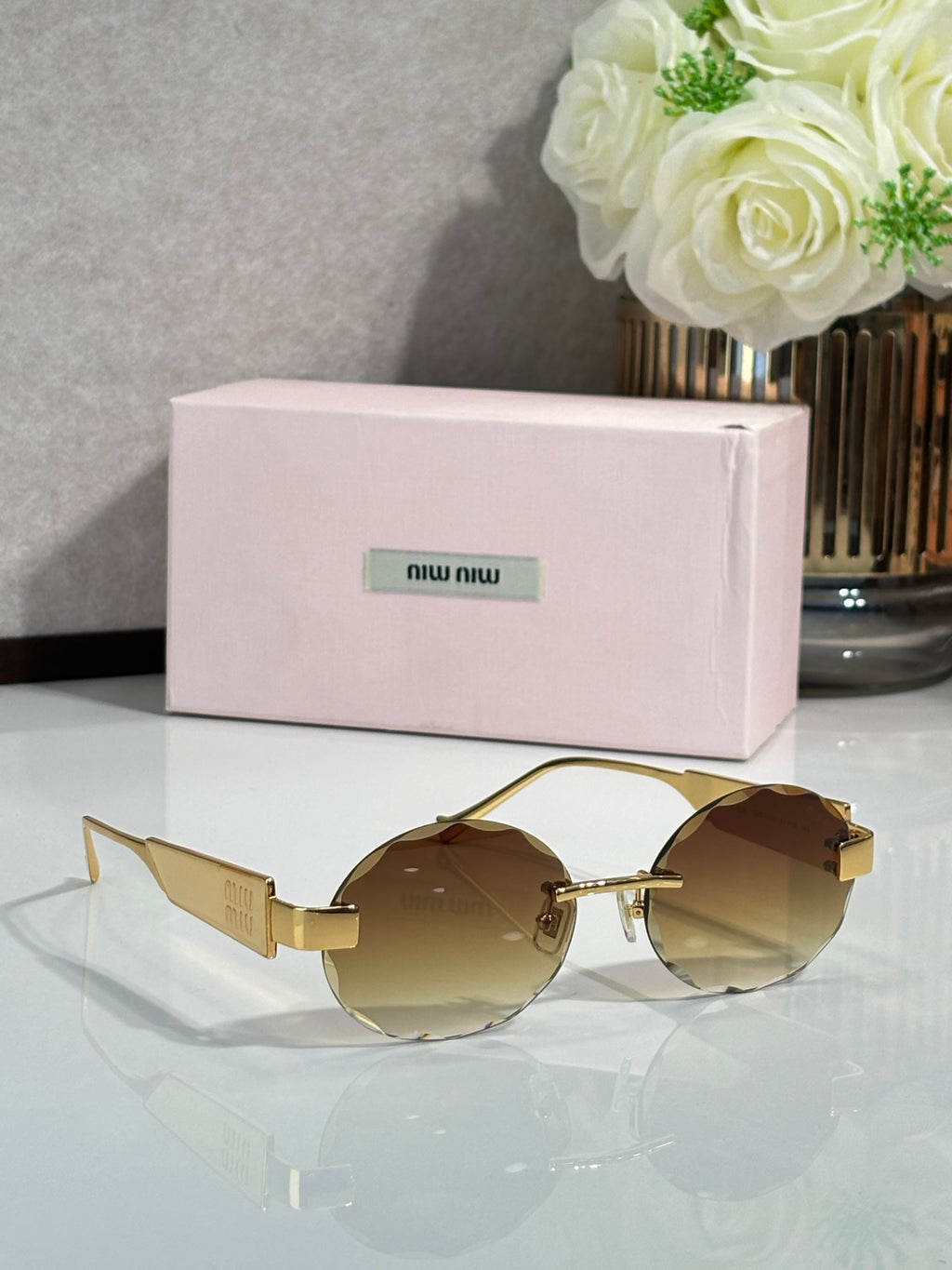 MiuMiu sunglasses with gold metal frame and brown round lenses