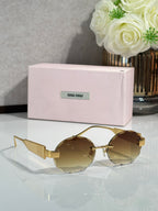 MiuMiu sunglasses with gold metal frame and brown round lenses