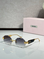 MiuMiu sunglasses with gold metal frame and dark lenses