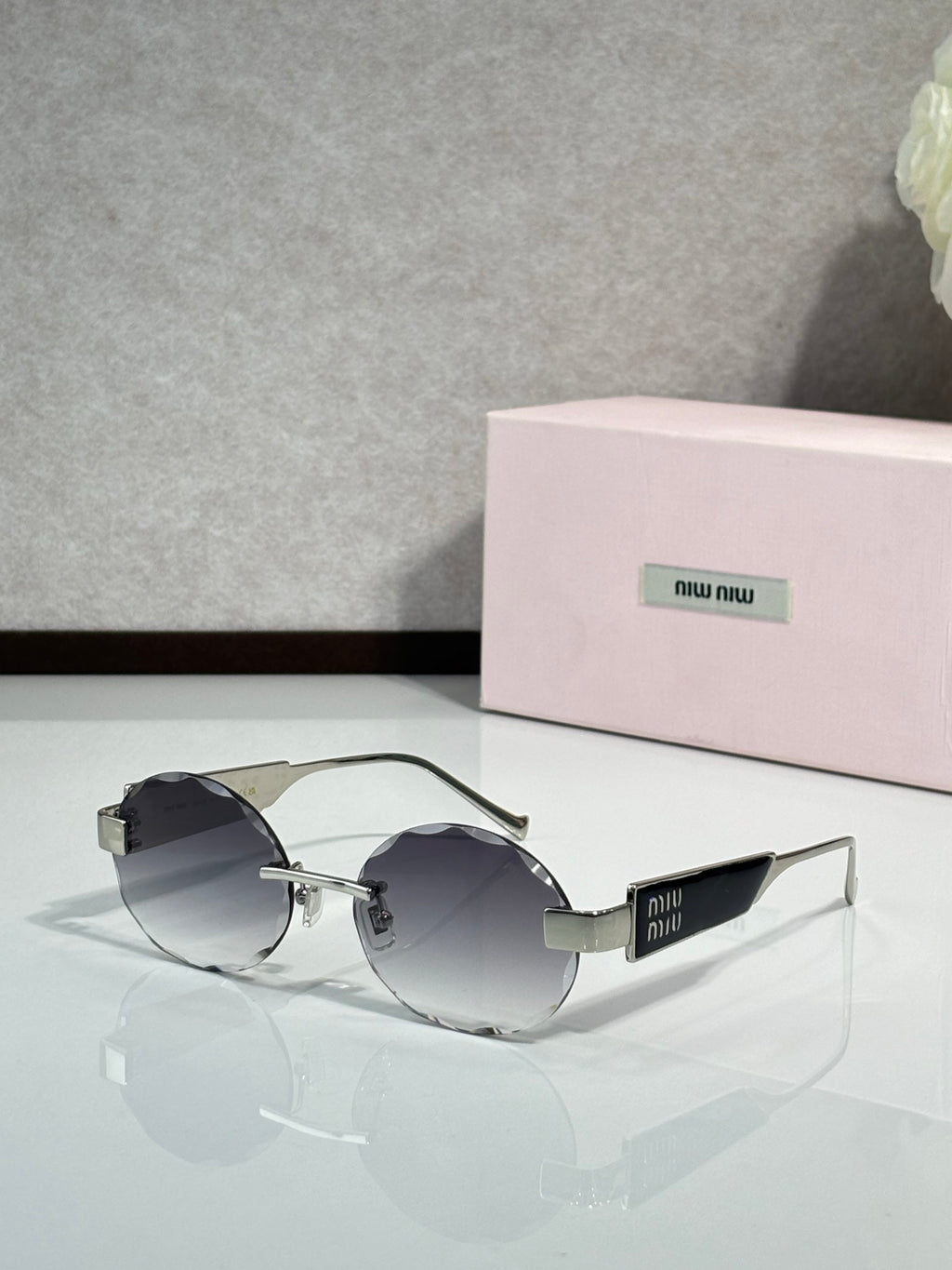 MiuMiu sunglasses with gold metal frame and dark gray lenses