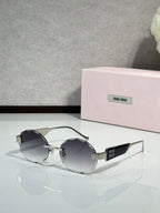 MiuMiu sunglasses with gold metal frame and dark gray lenses