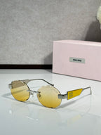 MiuMiu sunglasses with gold metal frame and yellow tinted lenses