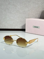 MiuMiu sunglasses with gold metal frame and amber tinted lenses