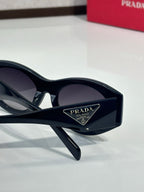 Prada black sunglasses with dark lenses and Prada Milano logo temple detail