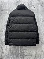 Long puffer jacket back view in dark color with standing collar