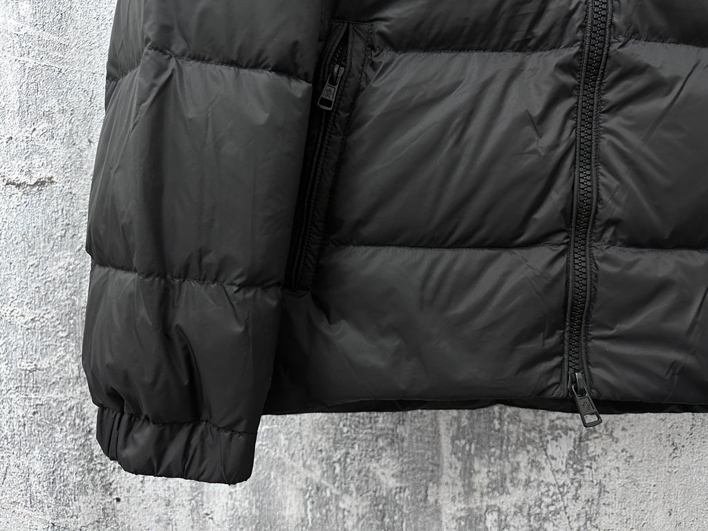 Long puffer jacket side with quilted panels, front zipper, and pocket