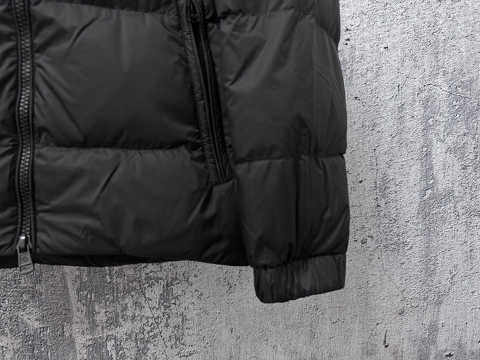 Long puffer jacket sleeve cuff with front zipper detail in dark color
