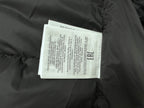Long puffer jacket interior label tag on dark fabric
