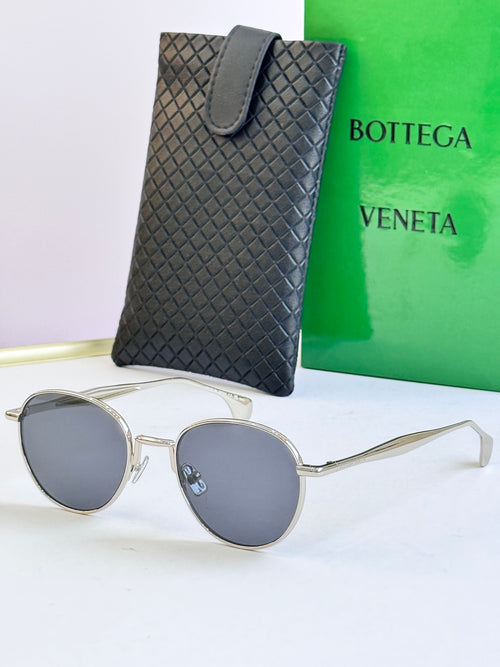 Round sunglasses with silver frame and dark gray lenses, with black leather case