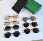 Assorted round sunglasses with mixed metal frames and lenses, with black leather case