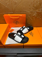 Hermes sandals with black sole and white strap bands, open-toe slip-on