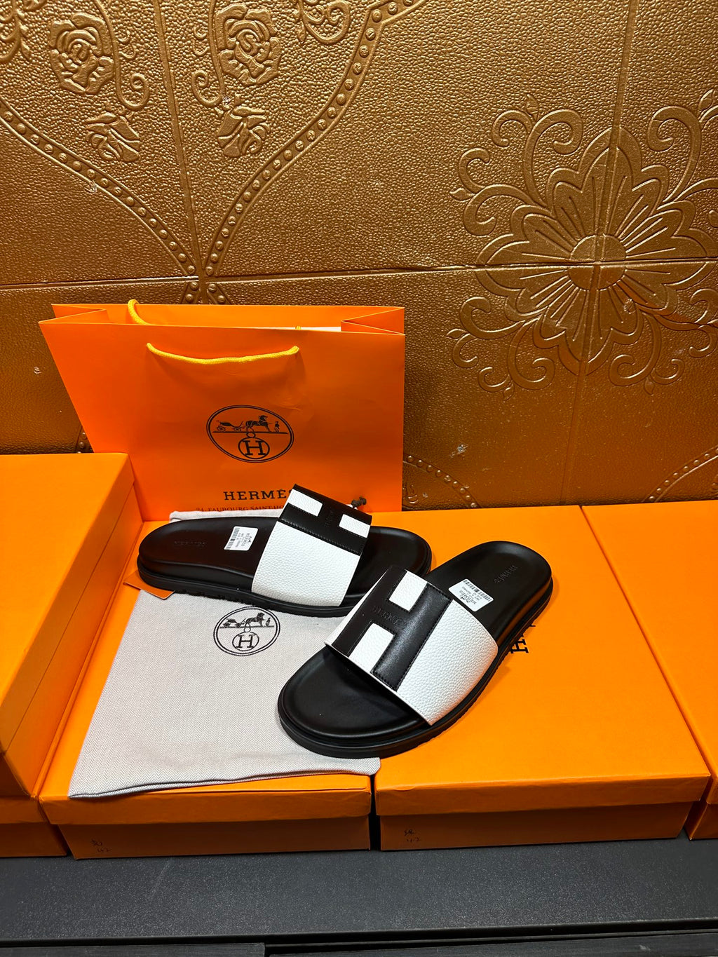 Hermes slide sandals pair, black base with white strap and black center blocks