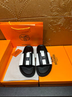 Hermes sandals with black base and white strap with black insets