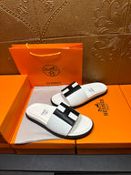 Hermes slide sandals in white with black H-style strap and open toe